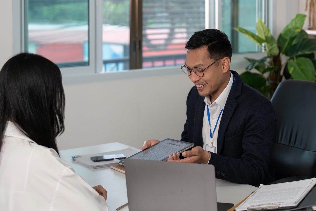 insurance consultation. professional discussing policy details with client in modern office.