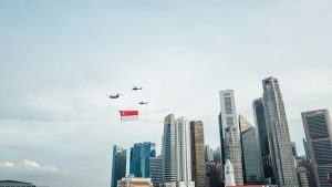 airplane flying over city buildings during daytime