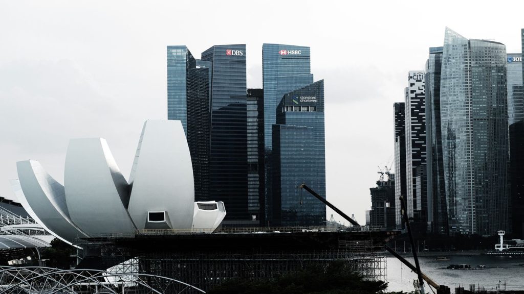 Modern buildings and a unique waterfront structure in singapore.