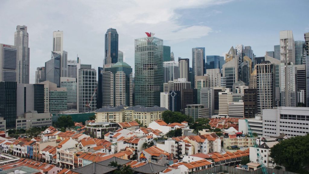 houses near high-rise buildings during daytime