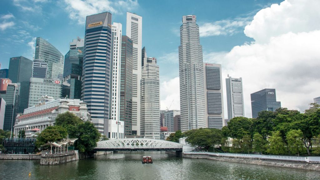 a body of water with a bridge and buildings in the background