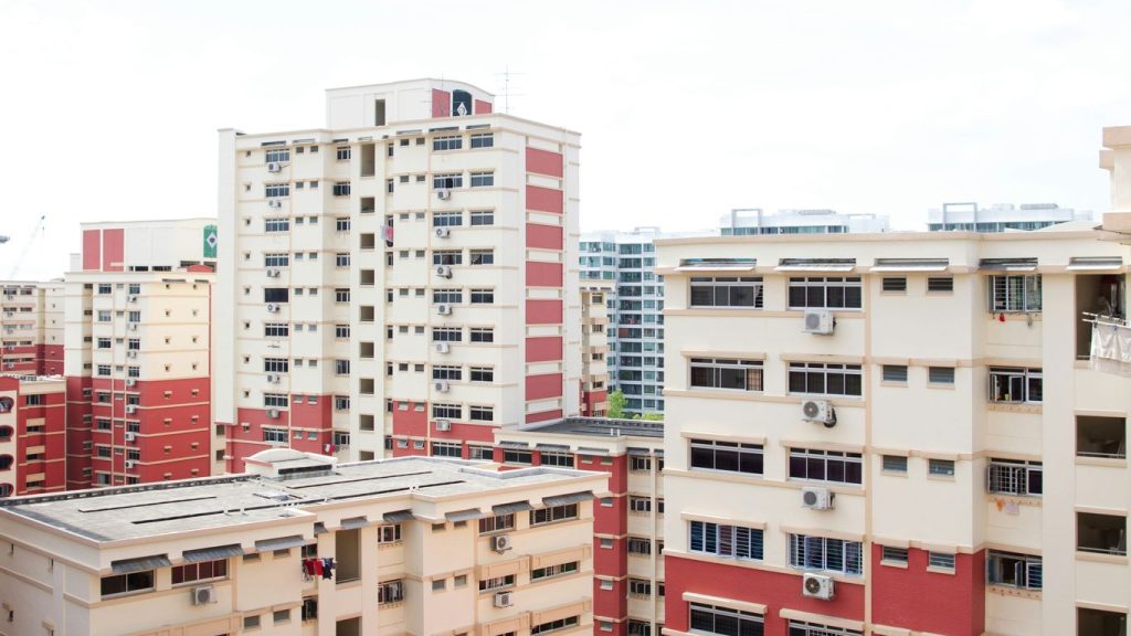 white concrete buildings under white clouds