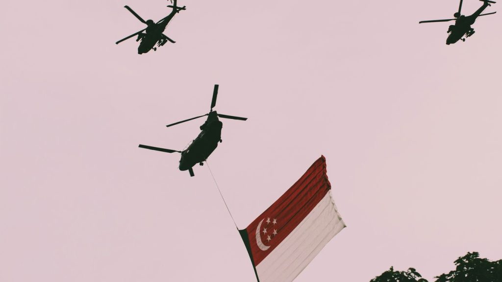 photo of three helicopters and one with flag