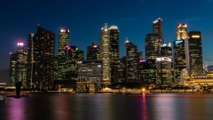 cityscape near the body of water with lights turned-on during nighttime