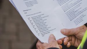 a close up of a person holding a piece of paper