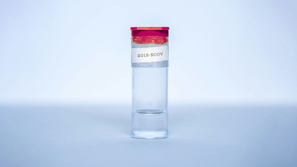clear glass bottle with red lid