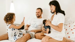 man in white crew neck t-shirt sitting beside woman in white crew neck t-shirt
