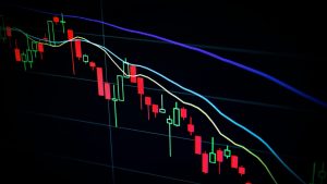stock market candlestick chart on dark screen