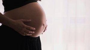 woman holding stomach