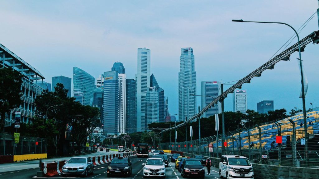 cars on road near high rise buildings during daytime