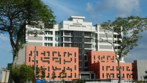 Modern hospital building with red crescent logo.