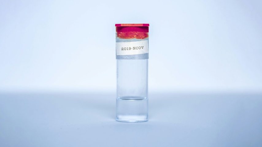 clear glass bottle with red lid