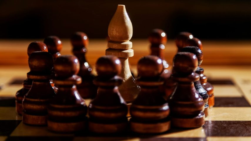 A bishop is surrounded by pawns on a chessboard.