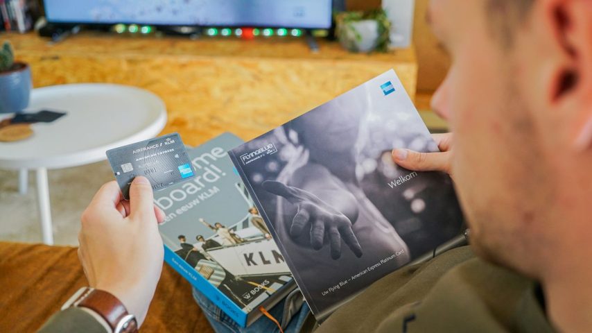 a man reading a book in front of a tv