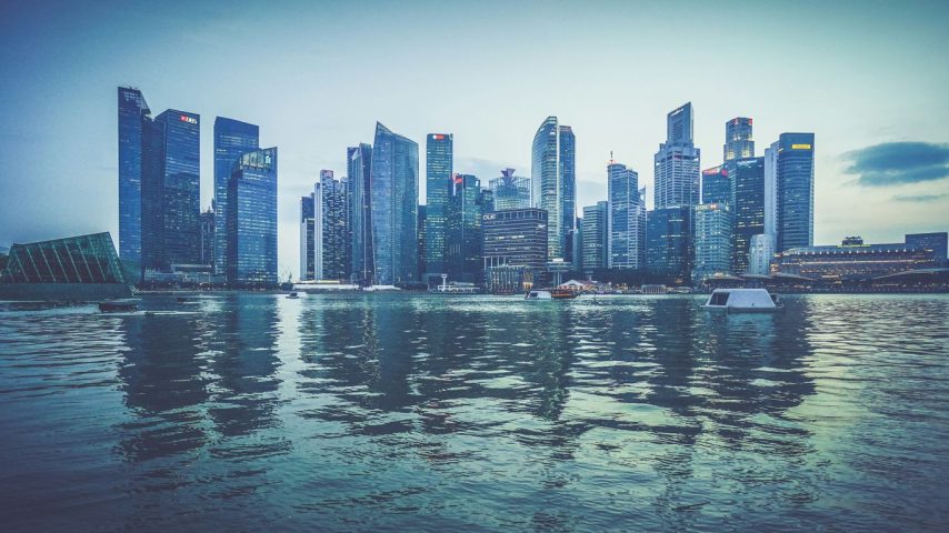 gray buildings near body of water at daytime