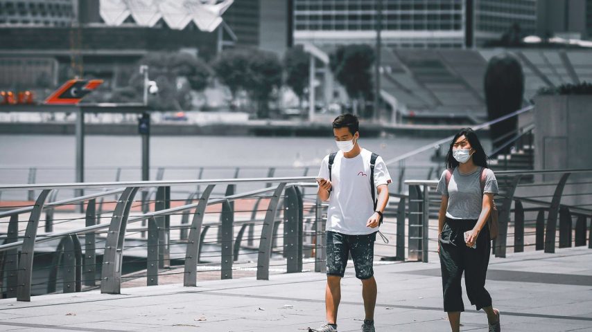 man in white crew neck t-shirt and black shorts standing beside woman in black tank