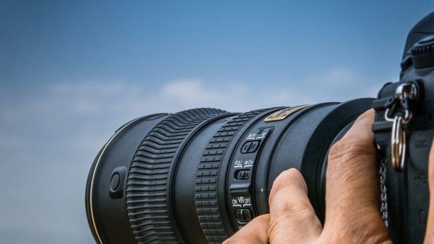 person using black DSLR camera