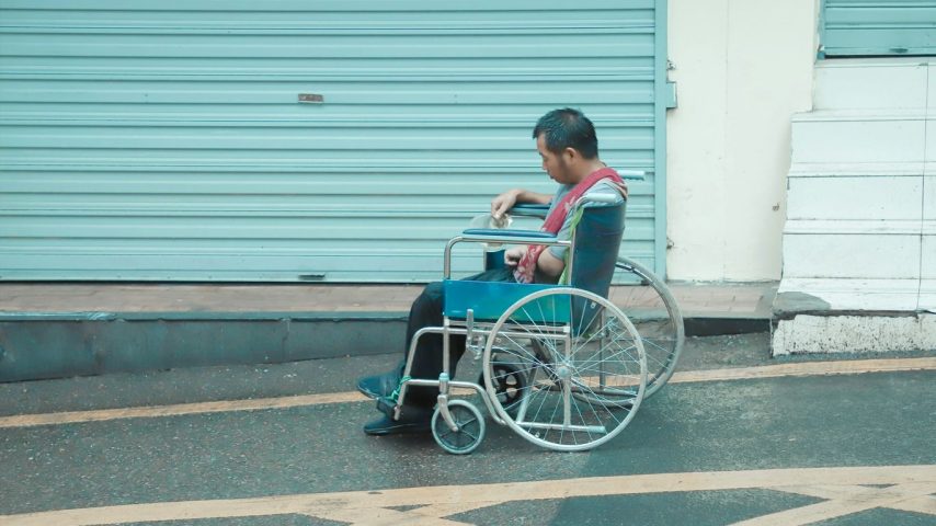man in red shirt sitting on wheelchair