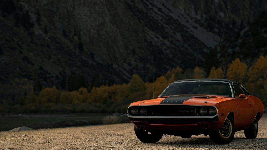 orange chevrolet camaro on dirt road during daytime